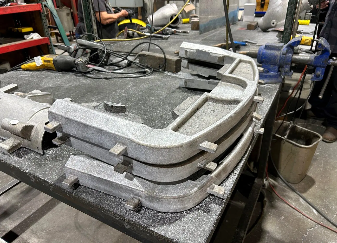 Sand castings being cut off and cleaned